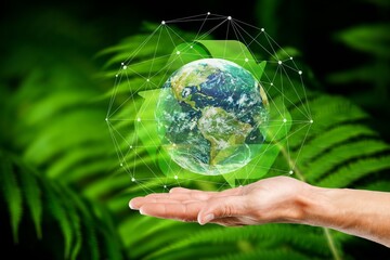 Hands hold Earth globe on nature background.