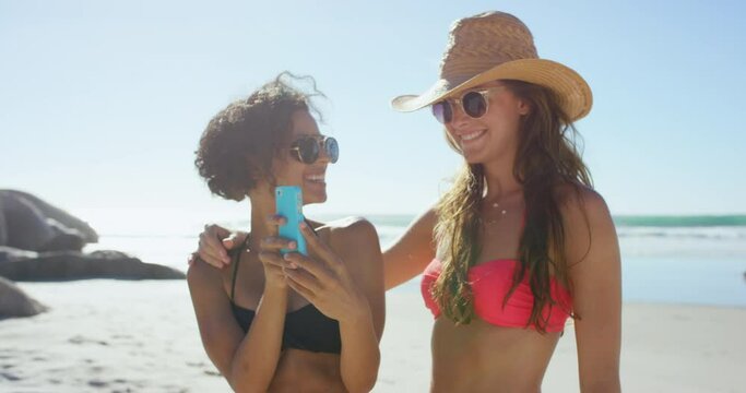 Summer, selfie and friends with phone at the beach enjoying holiday, vacation and weekend. Travel, nature and women having fun on adventure, journey and take pictures with smartphone for social media