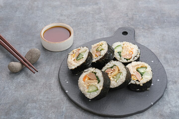 Korean Rolled Gimbap, made of rice, cucumber, tuna, carrot, sausage, crab stick and wrapped with seaweed laver. 

