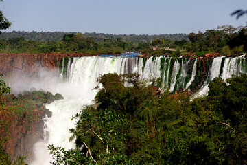 Tourists walk across a platform at Iguazú Falls