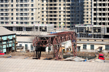 Crane and building construction site against blue sky 