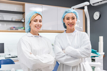 Portrait of Two young beautiful dentist stand at dental health clinic. 