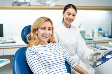 Portrait of Caucasian woman patient and dentist at health care clinic.