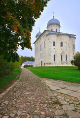 Fototapeta na wymiar St. George's Cathedral of the St. George Monastery. The path to the ancient monument of the XII century. Veliky Novgorod, Russia, 2022