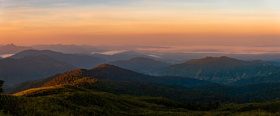 Thai female tourist Travel to Nan province in cafes and on the mountain where there is a coffee plantation in the morning with a view of the sunrise.