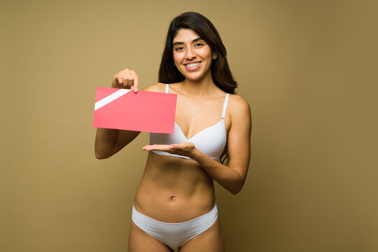 Beautiful young woman with a cosmetic procedure gift card