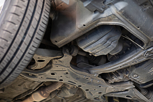 image of the underside of the car being lifted with a jack to check the condition of maintenance for safety according to use