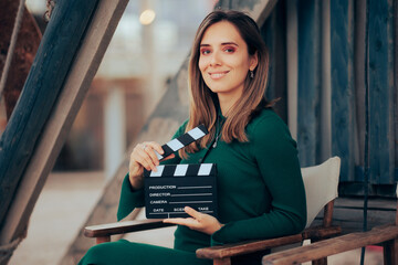 Beautiful Actress Holding a Film Slate Smiling at the Camera. Professional casting director...