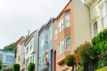 Row of multicolored houses or homes in the neighborhood in San Francisco California on a cloudy or foggy day downtown