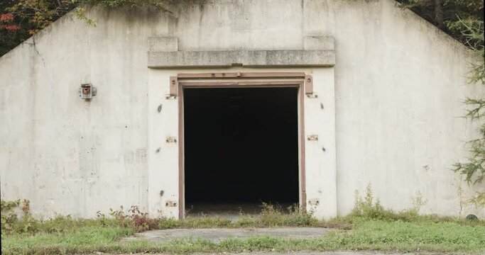 Closeup of the darkened doorway of an abandoned underground nuclear bunker in a remote area of the former Loring Air Force base near Limestone, Maine.