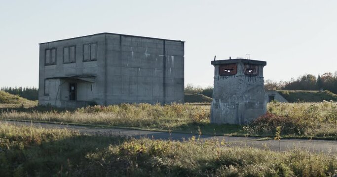 Wide shot of a machinegun pillbox guarding an abandoned nuclear facility with a bunker visible in the background at the special security area of Loring Air Force base near Limestone, Maine.