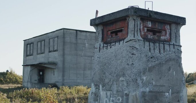 Closeup of a machine gun pill box standing sentry in front of an abandonded nuclear facility at the special security area of the former Loring Air Force base near Limestone, Maine.