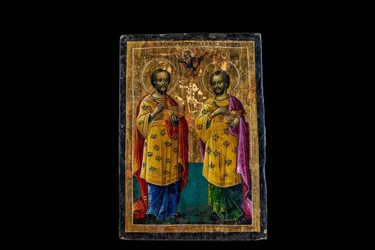Icon of Saint Cosmas and Saint Damian isolated on a black background