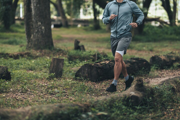 healthy lifestyle young fitness man running the forest. Outdoor workout,  Healthy lifestyle concept.