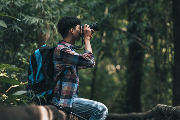 Hikers  with backpacks use camera shooting lanscape in the forest. hiking and adventure concept.