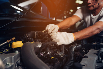 Closeup of auto mechanic are using the wrench to repair and maintenance auto engine is problems at car repair shop.