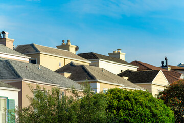 Family neighborhood in San Francisco California with decorative stucco houses in rows with sunlit roofs