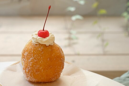 donut with cherry and cream on the table