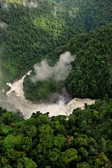 PNG-aerial view of rugged raging rivers and falls and dark forboding jungle in the highlands of Papua New Guinea