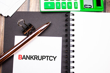 Bankruptcy text concept with calculator. Financial business concept.