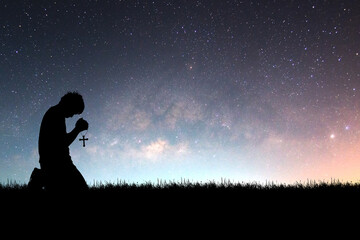 Man praying with hope against Milky Way background