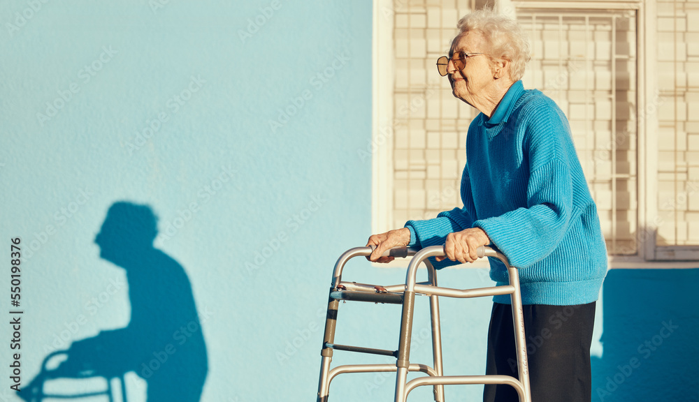 Wall mural Senior, walker and woman in a city with a disability, osteoporosis or arthritis walking with wall mockup. Relax fitness from leg rehabilitation after surgery with a elderly female walk for health