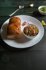 Ready to eat pav bhaji in a plate. Close up, selective focus.