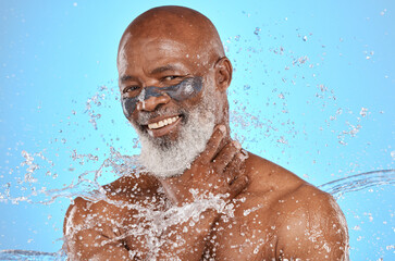 Skincare, water and portrait of black man with facial on blue background in studio for wellness, spa and cleanse. Cleaning, beauty and senior male with water splash, facial mask and luxury treatment