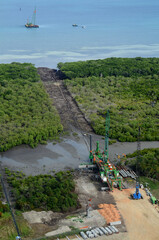 PNG- machinery claiming swampland and constructing a road to lay pipeline across to vessel , in Papua New Guinea re LNG gas.JPG