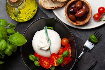 Burrata cheese, various tomatoes and olives