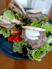 Pita stuffed with pork and minced meat Food styling for street food on wood table Closeup.