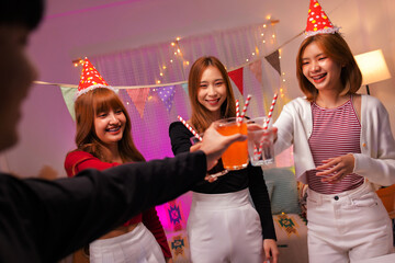 Group of Asian teenager friends celebrating together at home night party.