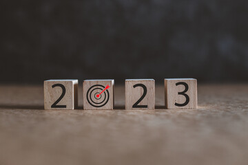 Happy new year 2023 . new year background target concept, wooden cubes  2023 with old background.