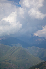 Fototapeta premium Vertically blurred landscape of high mountains in the clouds.