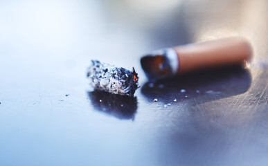 Smoke, ash and burning cigarette butt on table, tobacco addiction awareness and prevention of risk...