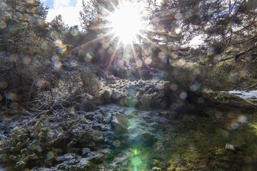 Obraz na płótnie Canvas slightly snowy stream in the mountains of the Sierra de Guadarrama in Madrid with the first snow of the year 2022