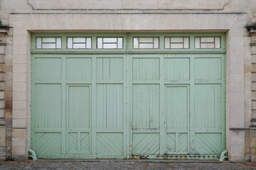Double Wooden green ancient garage door old blue building entrance closed