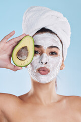 Avocado, woman skincare or face mask with fruit in wellness grooming, health or product facial on blue background. Zoom on beauty studio model portrait, food in hands or hair care towel for self care