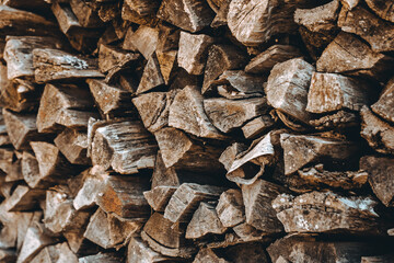 Chopped firewood pile. Woodpile wall. Heap of old dry pine woods. Brown textured background....