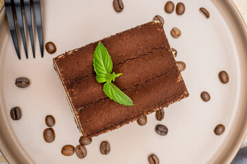 Coffee tiramisu and coffee beans on the plate