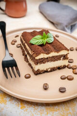 Coffee tiramisu and coffee beans on the plate