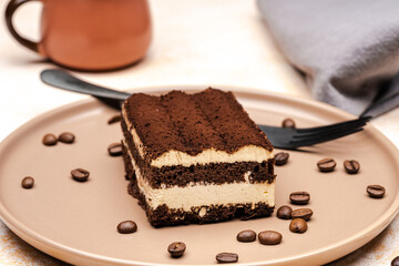 Coffee tiramisu and coffee beans on the plate