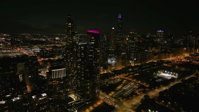 Aerial view of illuminated luxury condos and Grant park, night in Chicago, USA