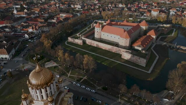 Panorama aerial drone flight over a orthodox church and the castle Cetatea Făgărașulu in Făgăraș in Rom&acirc;nia - Fagaras in Romania is a touristic city in the historical region of Transylvania