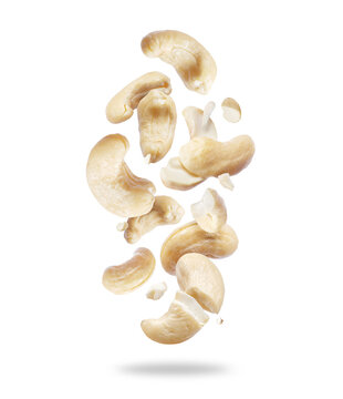 Whole and crushed cashew nuts close-up in the air on a white background