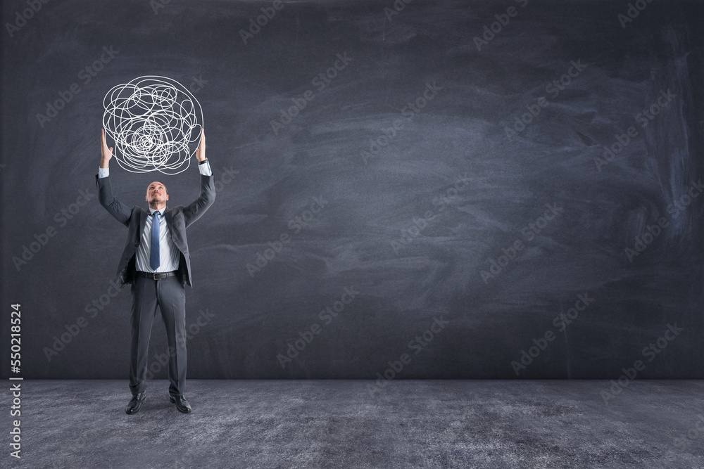 Poster young european businessman holding scribble of thoughts on chalkboard wall background with mock up p