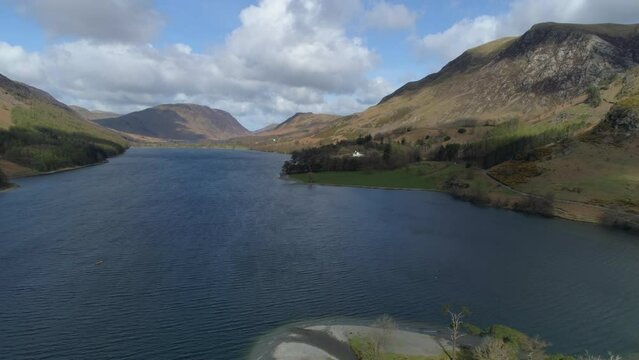 Aerial Drone Shot Looking Down Buttermere Lake with Robinson and Mellbreak Fell in View on Sunny and Cloudy Day Lake District Cumbria United Kingdom