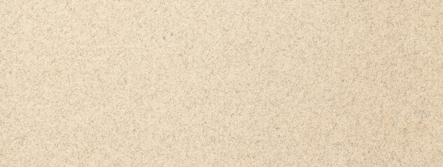 Texture of old light beige color paper background, macro. Structure of a vintage craft brown cardboard.