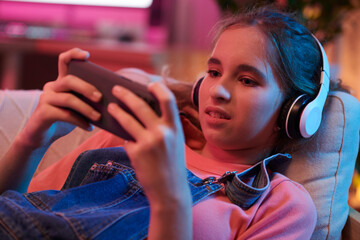 Girl Playing Videogame on Smartphone