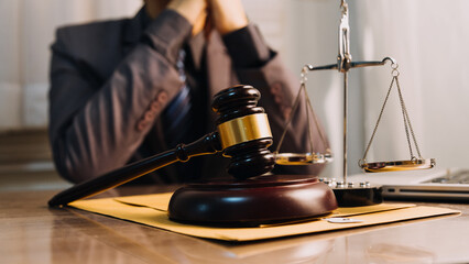 Justice and law concept.Male judge in a courtroom with the gavel, working with, computer and...